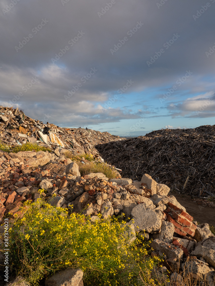 Path through rubbish heaps at recycling dump Path through rubbish heaps at recycling dump