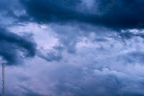 Fototapeta Naklejka Na Ścianę i Meble -  Blue hour sky clouds background. Beautiful landscape with stormy clouds and purple sun on sky