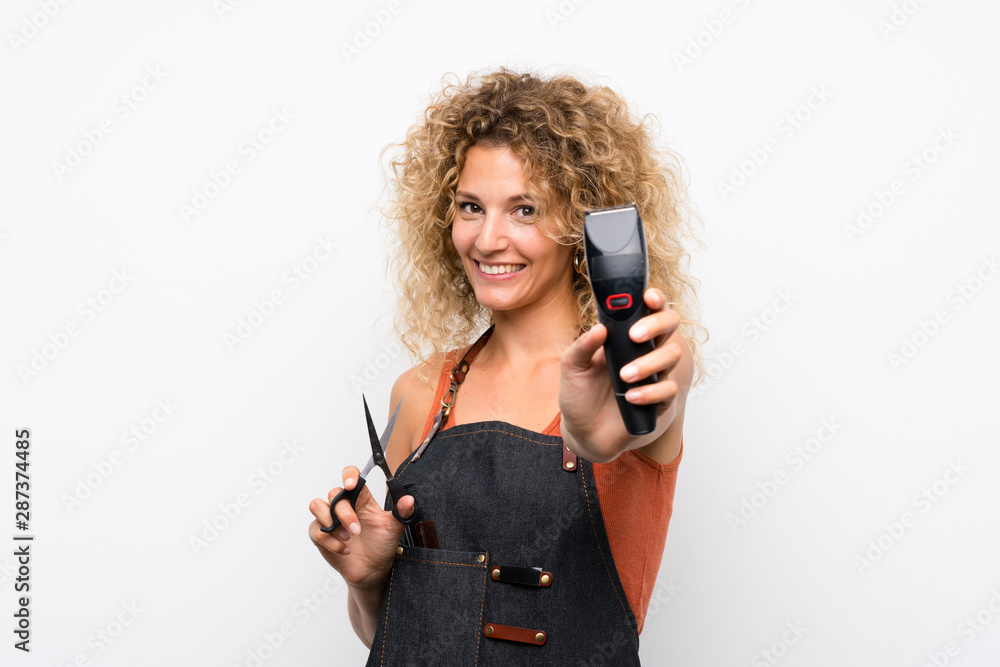 Young hairdresser woman over isolated background Young hairdresser woman over isolated background