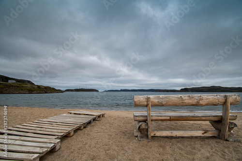 Lonely bench by the sea in autumn