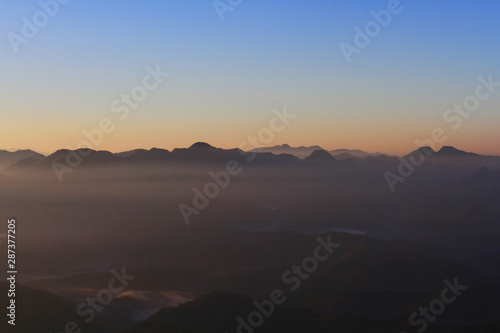 Beautiful Sunset and sunrise on sky and golden twilight time with mist and fog in valley of mountain layer