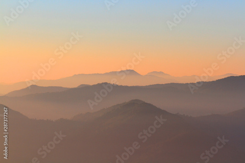 Beautiful Sunset and sunrise on sky and golden twilight time with mist and fog in valley of mountain layer © cocorattanakorn