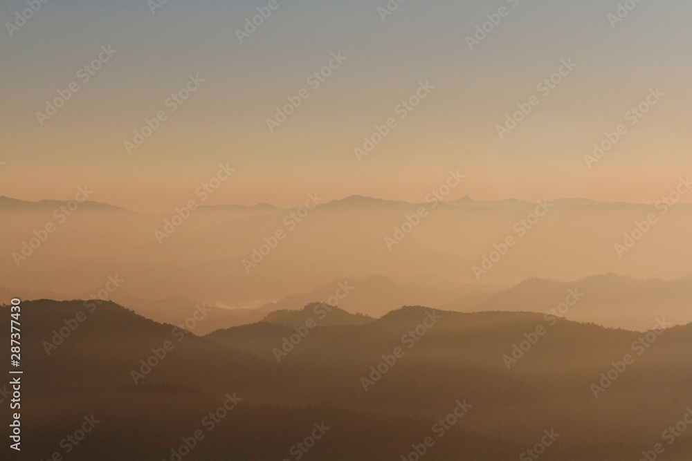 Beautiful Sunset and sunrise on sky and golden twilight time with mist and fog in valley of mountain layer