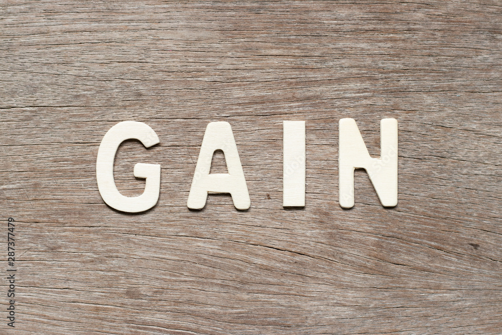 Alphabet letter in word gain on wood background Alphabet letter in word gain on wood background