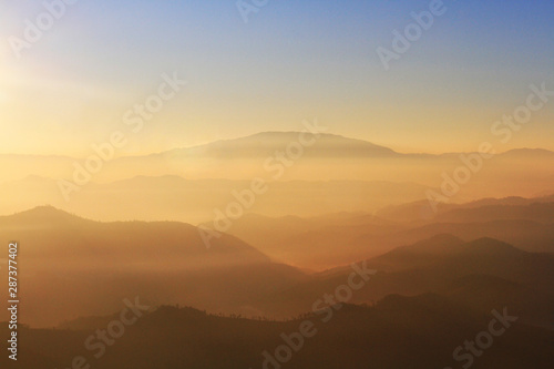 Beautiful Sunset and sunrise on sky and golden twilight time with mist and fog in valley of mountain layer © cocorattanakorn