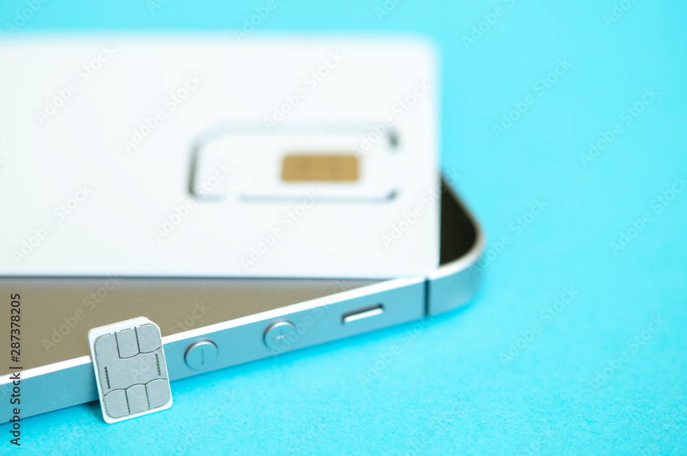 Fototapeta premium micro and mini SIM card and smartphone on blue background
