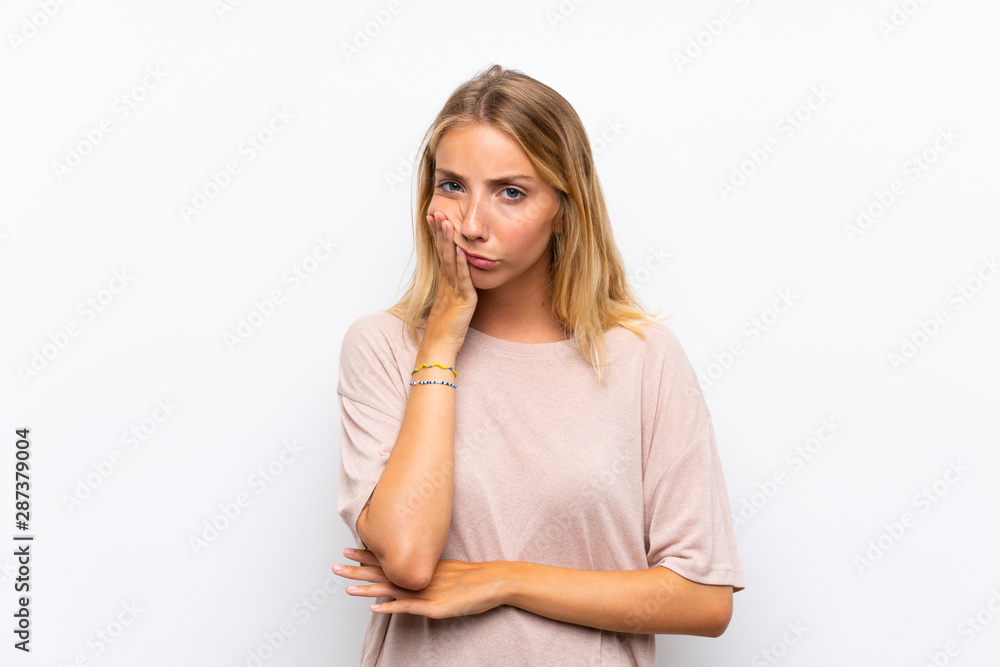 Blonde young woman over isolated white background unhappy and frustrated Blonde young woman over isolated white background unhappy and frustrated