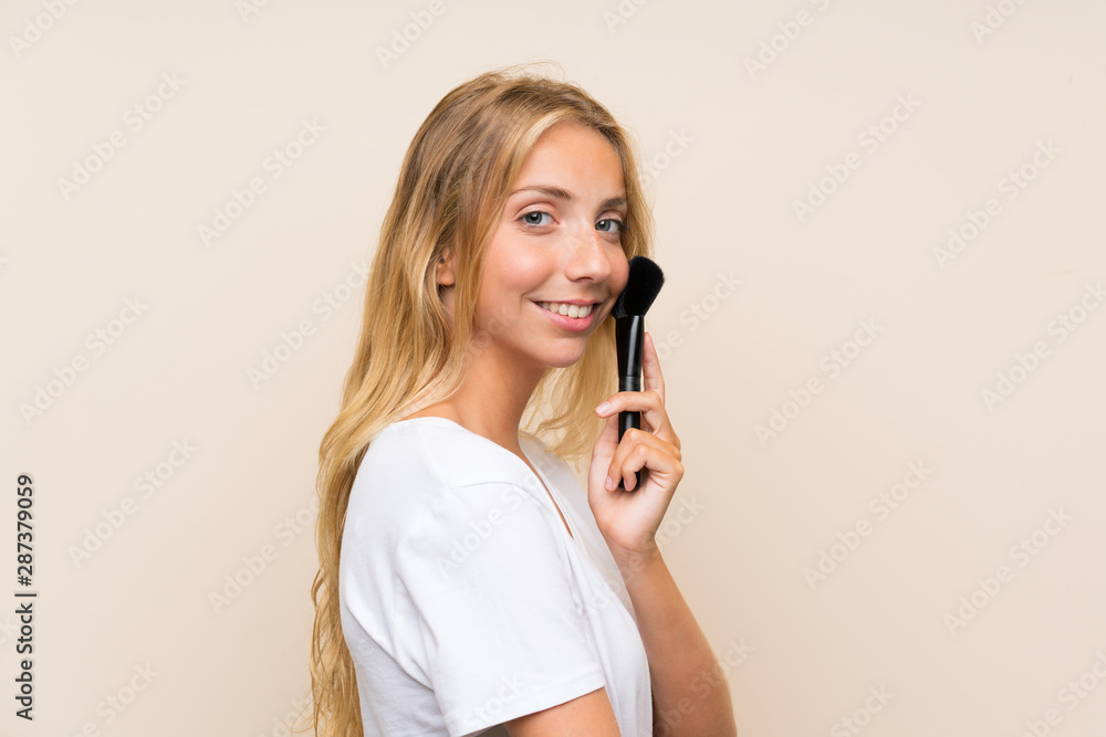 Happy Young blonde woman with makeup brush. Happy Young blonde woman with makeup brush.