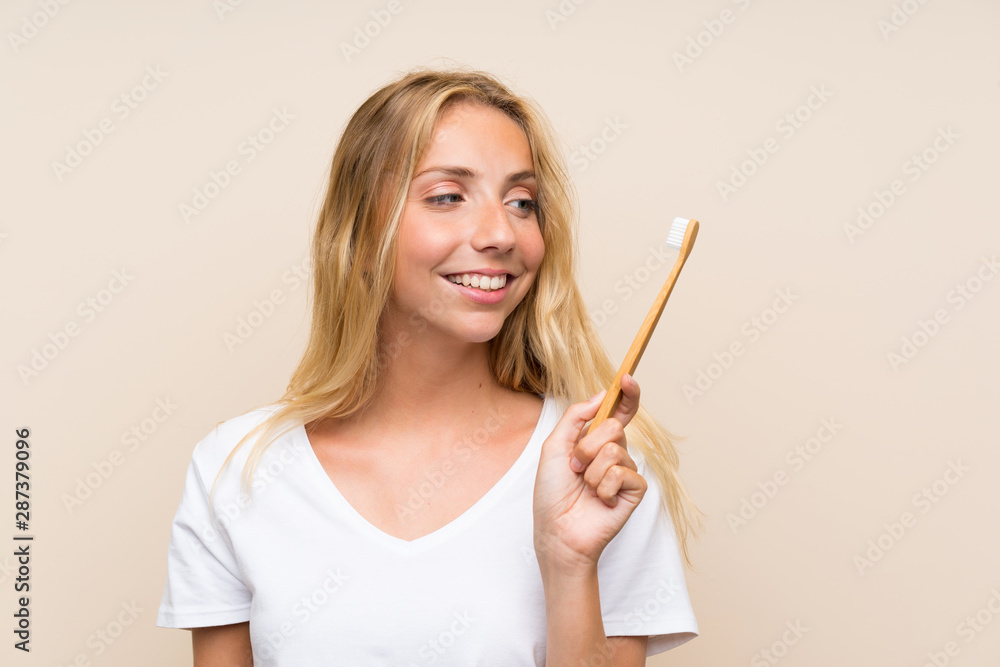 Happy Young blonde woman brushing teeths Happy Young blonde woman brushing teeths