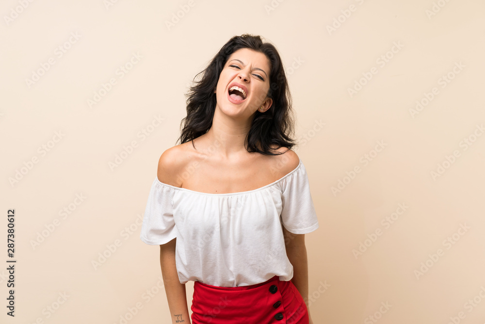 Young woman over isolated background shouting to the front with mouth wide open Young woman over isolated background shouting to the front with mouth wide open