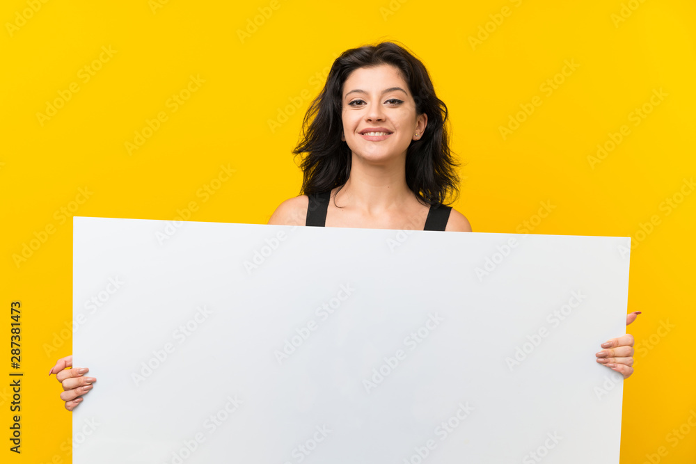 Young woman over isolated yellow background holding an empty white placard for insert a concept Young woman over isolated yellow background holding an empty white placard for insert a concept