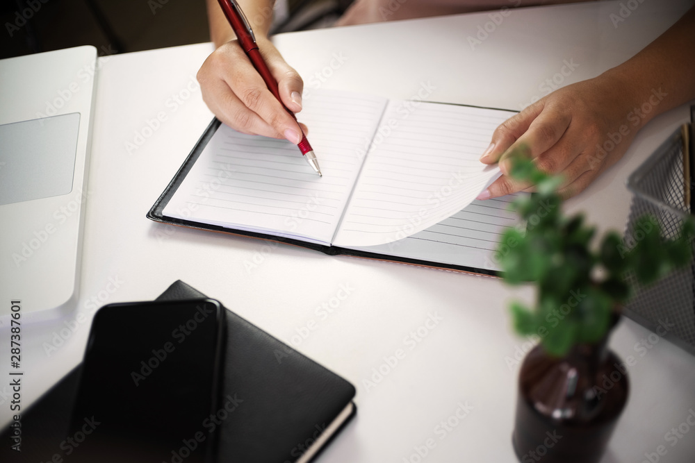 young woman writing on notebook at home. young woman writing on notebook at home.
