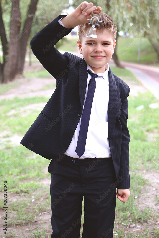 schoolboy boy rings a small bell on September 1 schoolboy boy rings a small bell on September 1