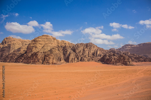 picturesque desert scenery landscape background photography with big sand valley foreground and huge mountain ridge background 
