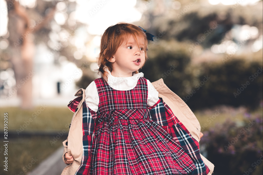 Stylish baby girl 1 2 year old wearing autumn jacket and checkered
