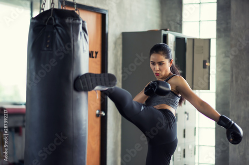 Woman practice Thai kick boxing in gym © Blanscape