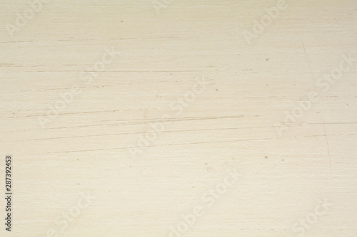 Texture of scratches on cream wood material, abstract background. Scratched cream wood surface background.