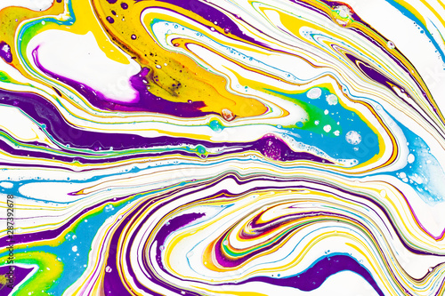 Acrylic paint waves abstract background. Rainbow marble texture. Oil paint liquid flow colorful wallpaper. Creative violet, yellow, blue fluid effect backdrop.