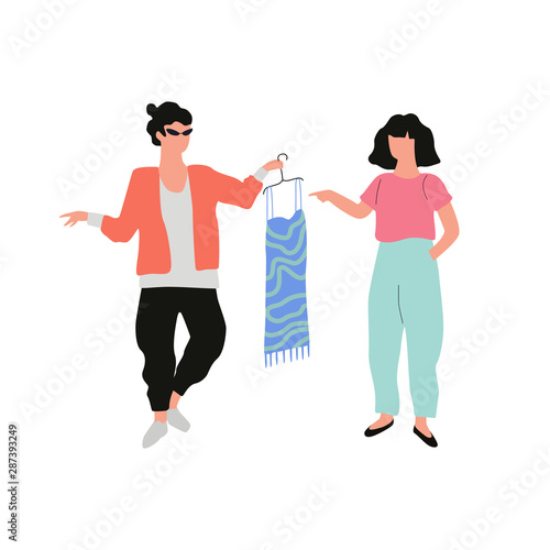 Man stylist holding a fashion dress for the woman