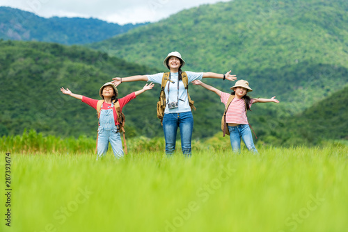 Group asian family children raise arms and standing see mountain outdoors, adventure and tourism for destination leisure trips for education and relax in nature park. Travel vacations and Life Concept