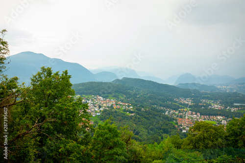 View Over Landscape with Mountain Range and Village in Lugano, Ticino, Switzerland. photo