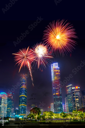 Celebration firework in twilight night cityscape of guangzhou urban skyscrapers at storm with lightning  bolts in night purple blue sky, Guangzhou, China © lukyeee_nuttawut