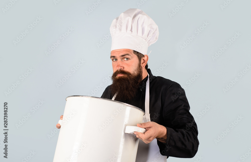 Professional chef in uniform and hat holds pan. Cooking pot. Cooking, food, profession concept - male chef holds pot. Chef, cook or baker with saucepan in hand. Chef in uniform cooking with casserole. Professional chef in uniform and hat holds pan. Cooking pot. Cooking, food, profession concept - male chef holds pot. Chef, cook or baker with saucepan in hand. Chef in uniform cooking with casserole.