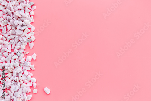 Design with pebble frame on pink background top view space for text