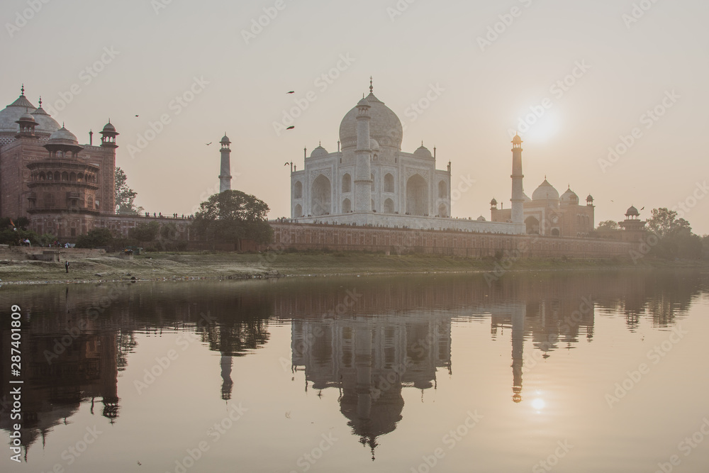 Taj Mahal on sunset mirroring on the water - Agra India 