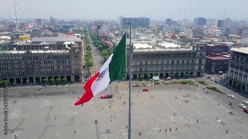 Mexico City - aerial view, the zocalo in mexico city, with the cathedral and giant flag in the centre, Mexican Flag waving high over Mexico, Constitution Plaza photo