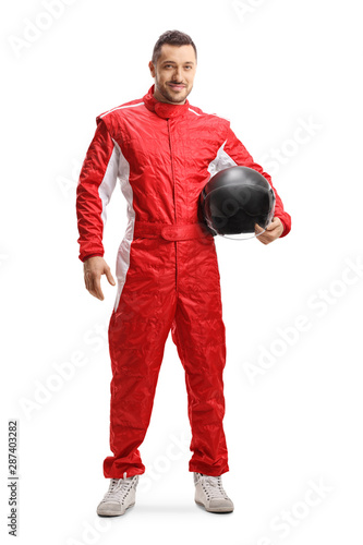 Fototapeta Racer in a red uniform holding a helmet and smiling