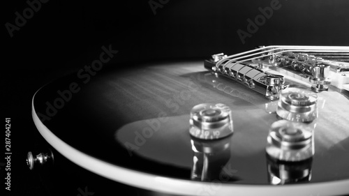 electric guitar . dark background . black and white .