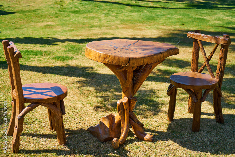 Fototapeta premium wooden table and chair on grass