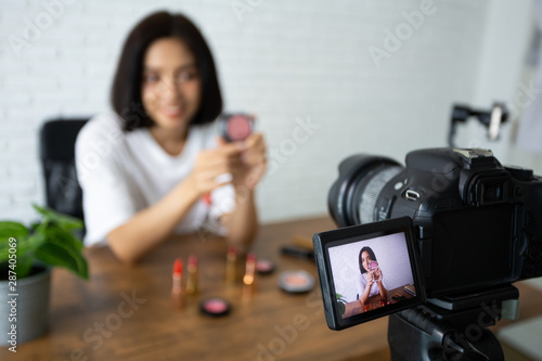 Beauty bloggers, Asian Women Showing cosmetic products while recording videos and giving advice for her beauty blog