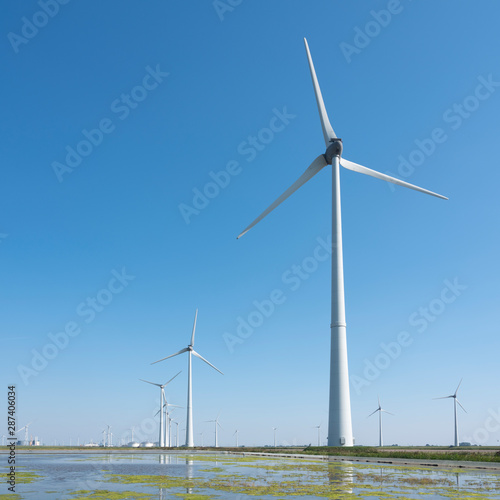 wind turbines and blue sky in the north of dutch province groningen near eemshaven