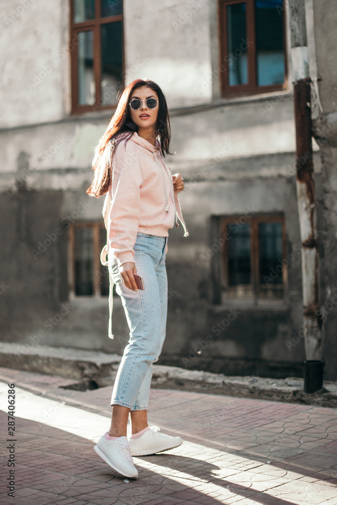 Beautiful model posing for the camera on the streets. Beautiful model posing for the camera on the streets.