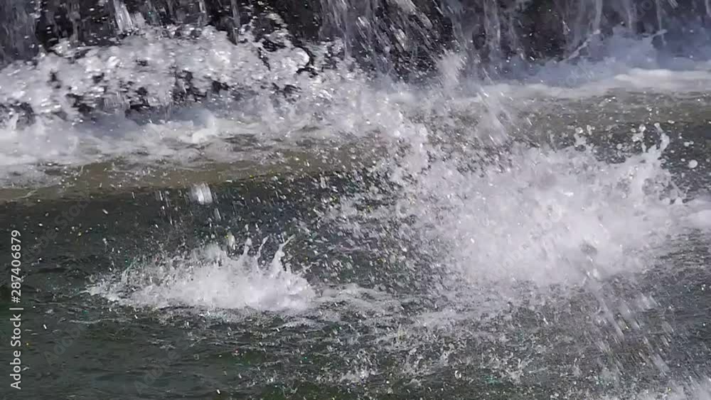Fountain jets slow motion falling down into fountain pond. Falling water drops. Fountain jets slow motion falling down into fountain pond. Falling water drops.