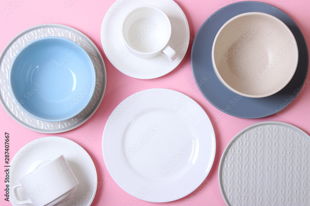 Set of dishes and kitchen utensils on a colored background top view. Set of dishes and kitchen utensils on a colored background top view.
