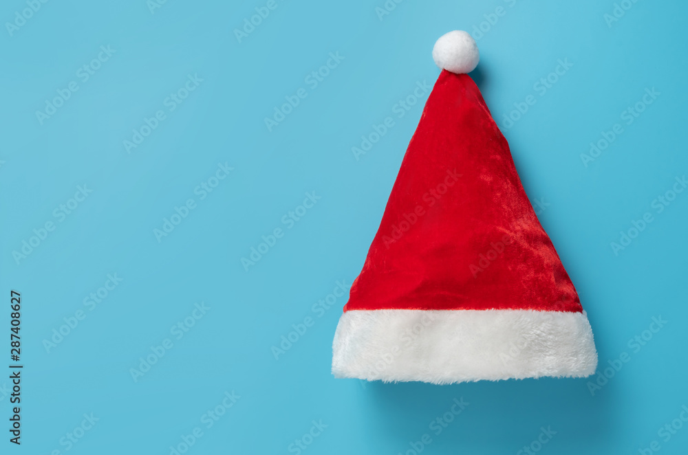 Top view of Santa claus hat on blue background.