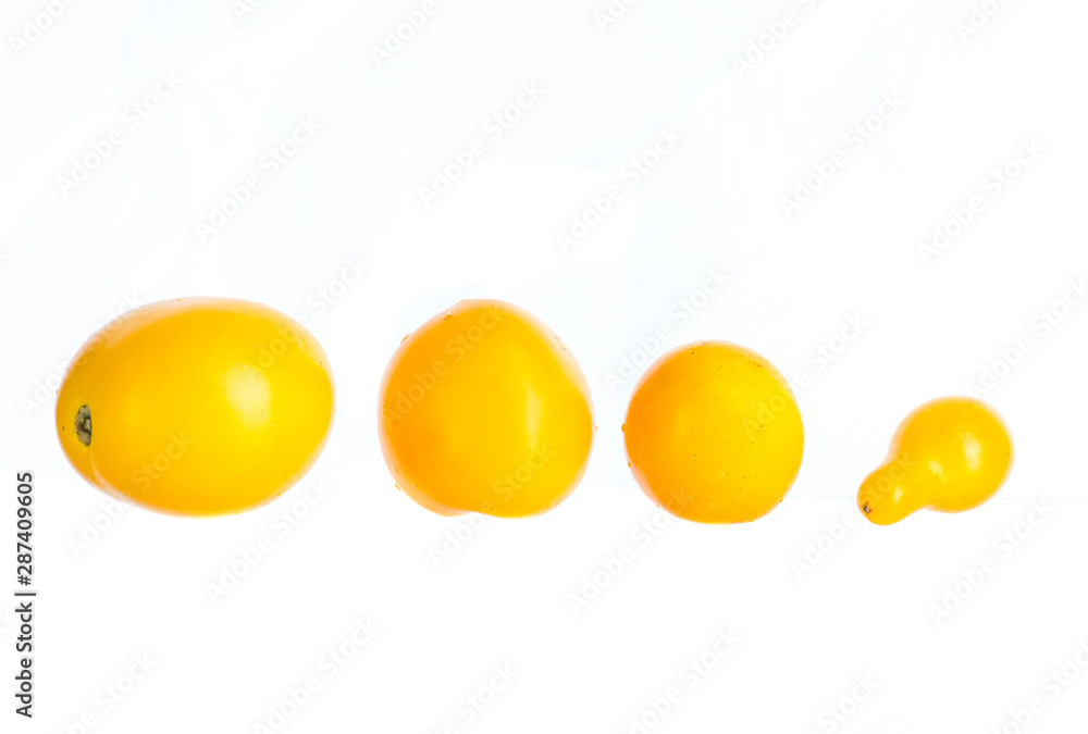 small yellow tomatoes a few pieces on a white background
