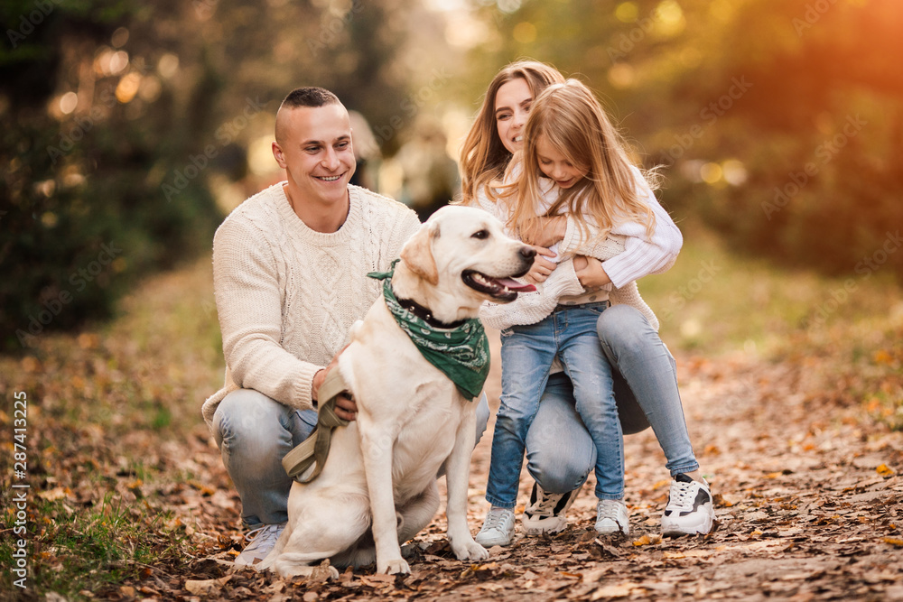 Happy family is having fun with dog labrador outdoors. Happy family is having fun with dog labrador outdoors.