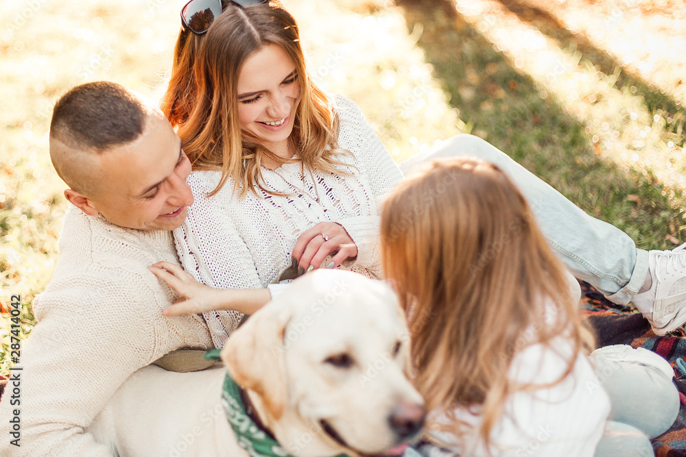 Happy family is having fun with dog labrador outdoors. Happy family is having fun with dog labrador outdoors.