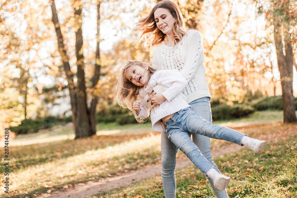 Happy daughter with mother is having fun walking in the park. Happy daughter with mother is having fun walking in the park.