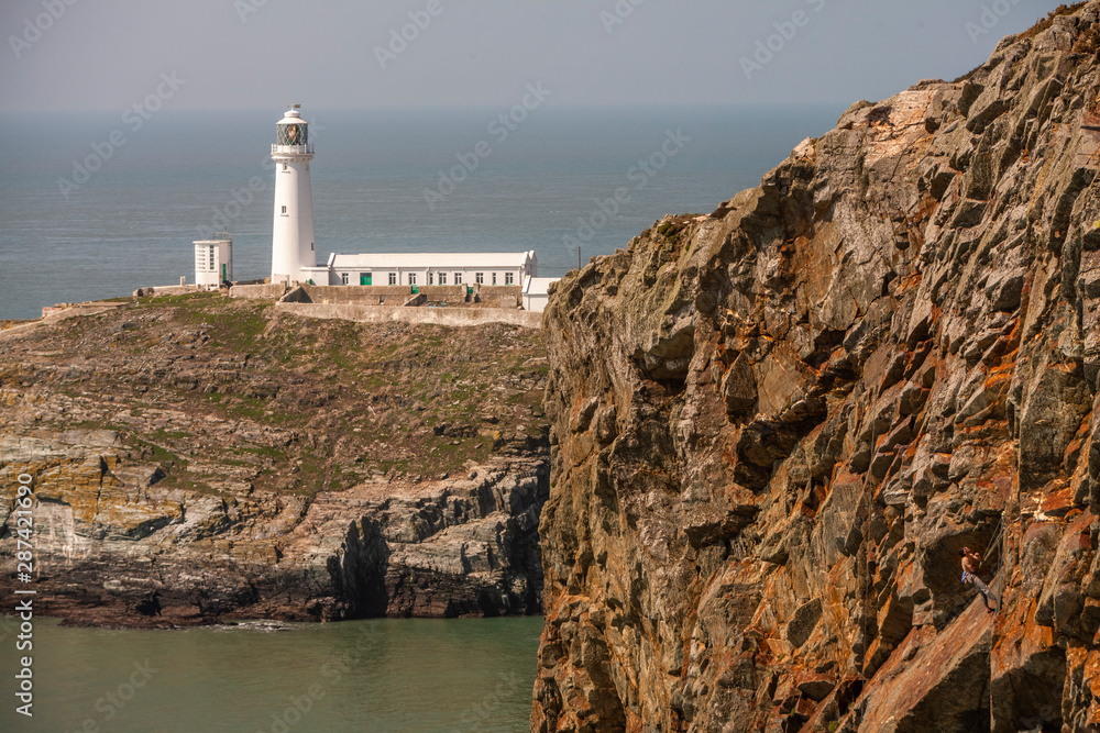 The South Stack Lighthouse is built on the summit of a small island off the north-west coast of Holy Island, Anglesey, Wales. It was built in 1809 to warn ships of the dangerous rocks below.