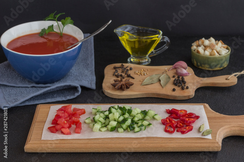 Summer tomato soup, set of products for gazpacho, black background