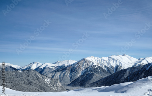 Snow-capped mountain peaks of the Caucasus mountain range near the resort of Arkhyz. Mountain peaks covered with snow in winter. Winter landscape. © Igor Luschay