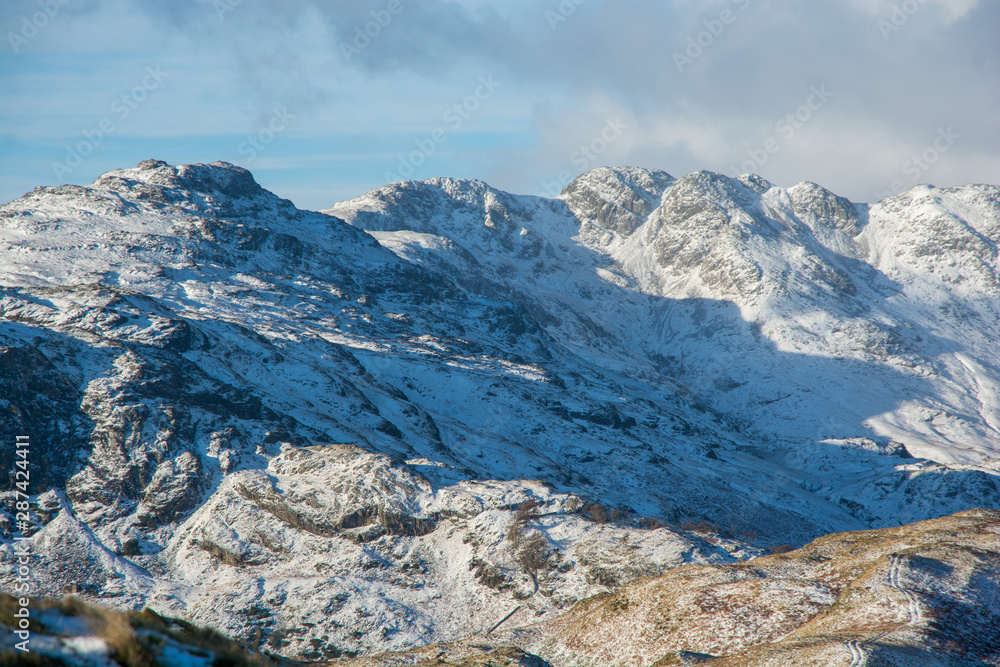 Winter view of Langdale in the English Lake District with snow covered fells in the sunshine