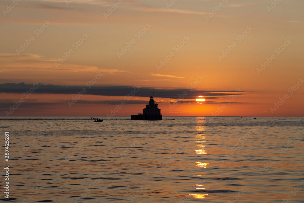 sunrise over lake and mouth of Manitowoc river Lighthouse at Manitowoc Harbor on Lake Michigan in Wisconsin