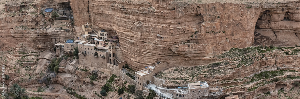 Monastery of Saints George and John Jacob of Choziba is Wadi Qelt. The cliff-hanging complex with its ancient chapel and gardens, nhabited by Greek Orthodox monks. Panorama