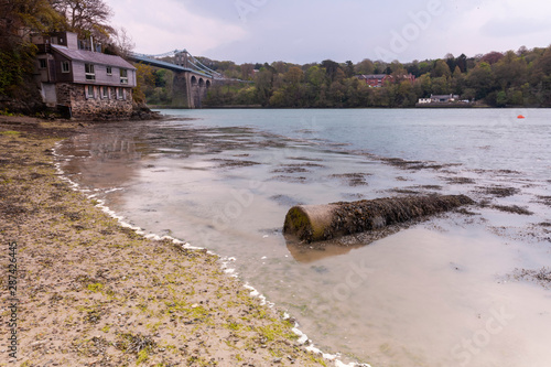 The Menai Strait is a narrow stretch of shallow tidal water about 25 km long, which separates the island of Anglesey from the mainland of Wales.  photo